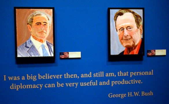 Portraits of former Presidents Goerge W. Bush, left, and his father George H.W. Bush which are part of the exhibit "The Art of Leadership: A President's  Diplomacy," are on display at the George W. Bush Presidential Library and Museum in Dallas, Friday, April 4, 2014. The exhibit of world leader portraits painted by George W. Bush opens Saturday and runs through June 3.  (AP Photo/Benny Snyder)
